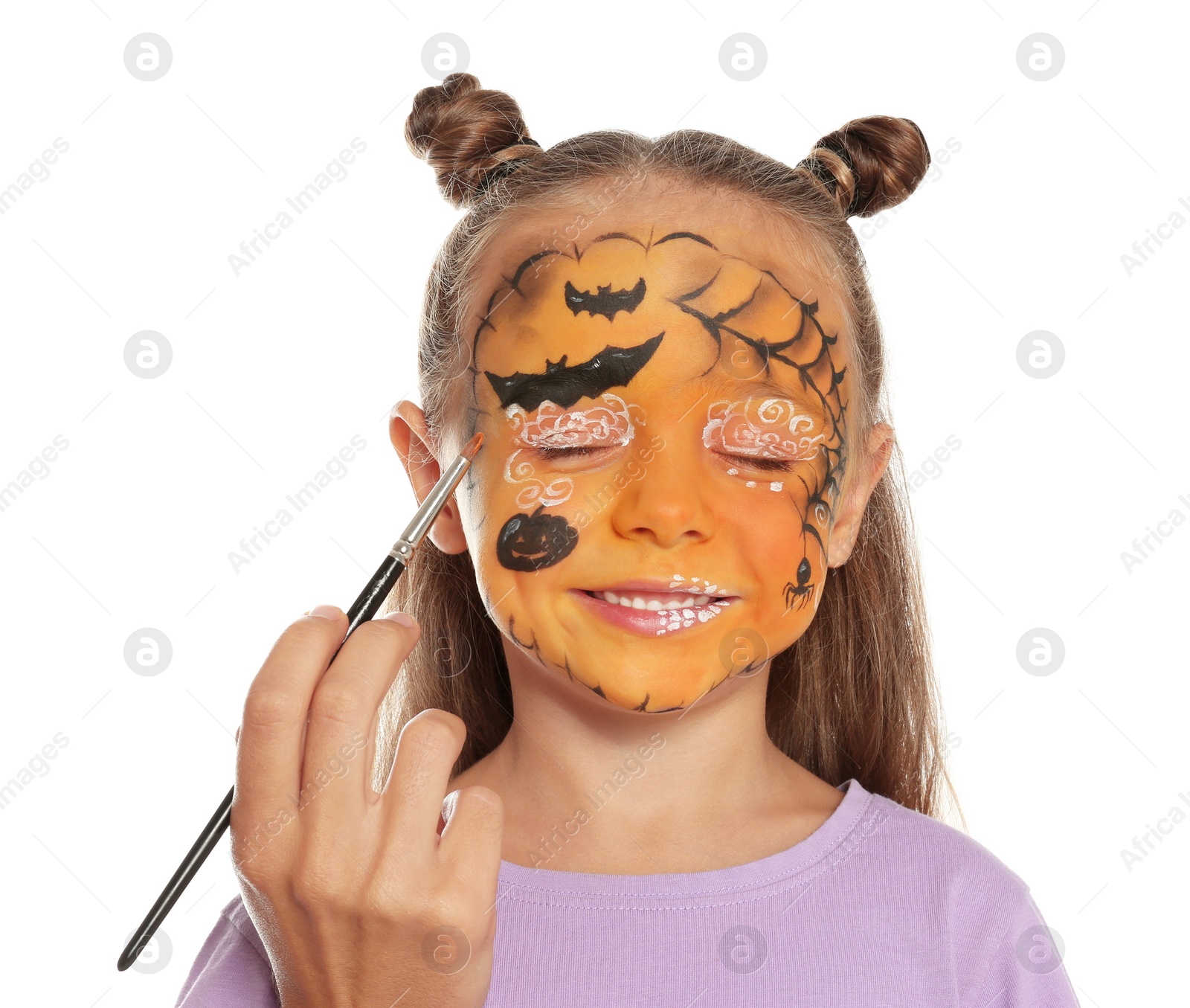 Photo of Artist painting face of little girl on white background