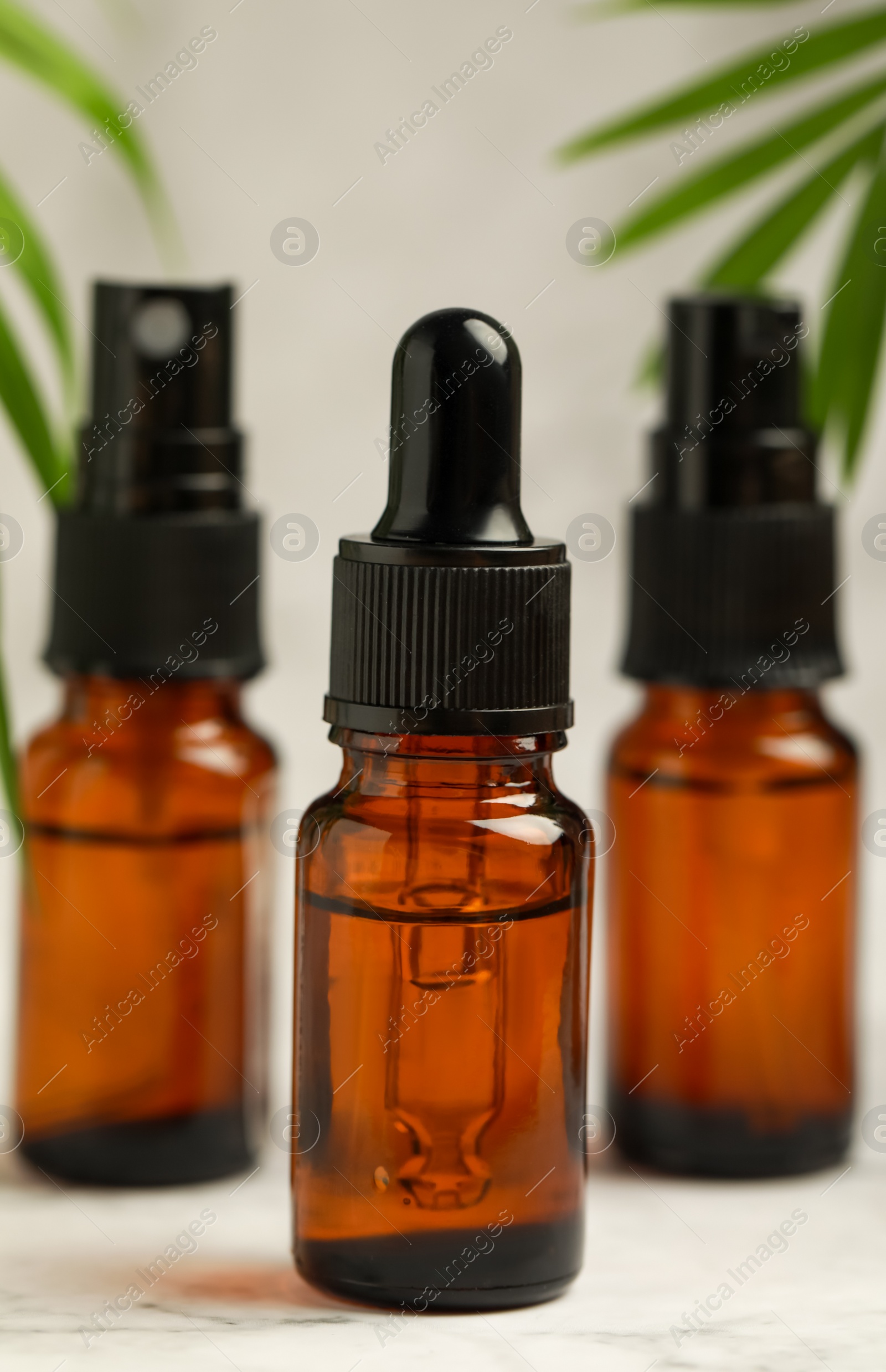 Photo of Bottles of organic cosmetic products on light background, closeup