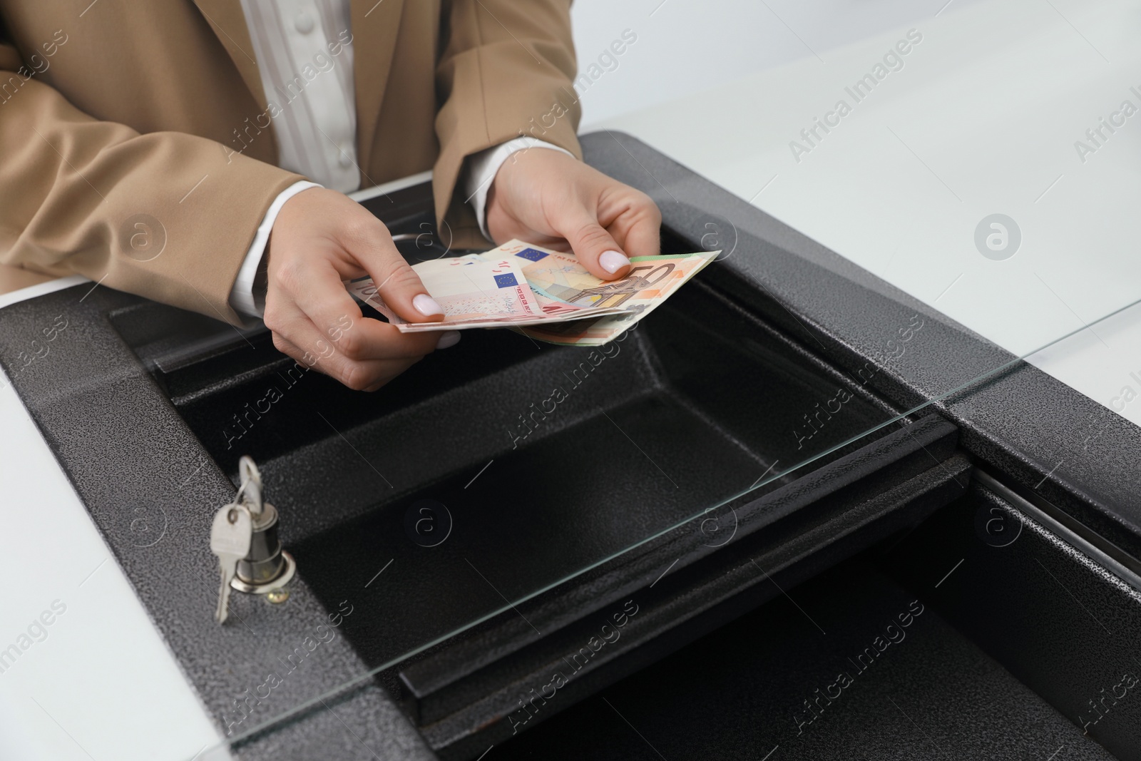 Photo of Cashier with money at bank, closeup. Currency exchange
