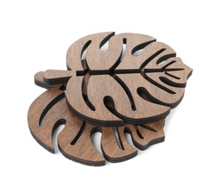 Photo of Leaf shaped wooden cup coasters on white background