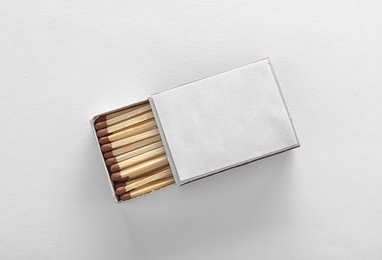 Cardboard box with matches on white background, top view. Space for design