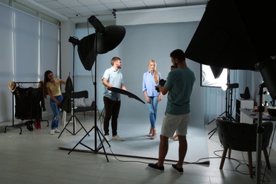 Professional team working with model in photo studio