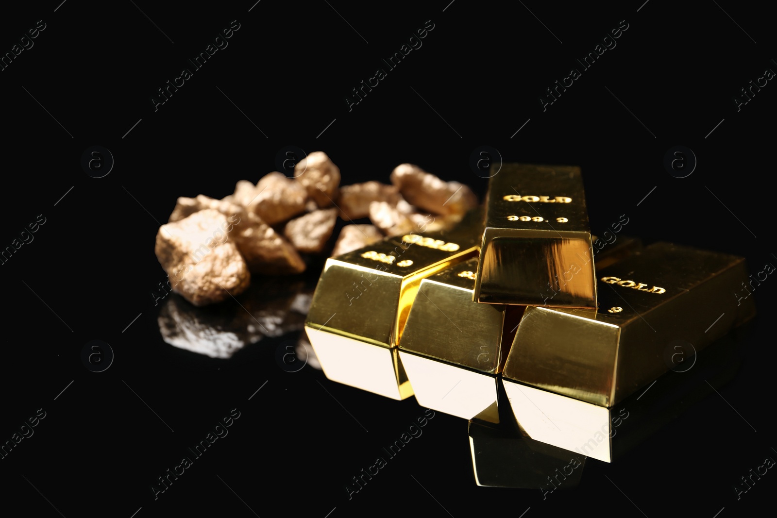 Photo of Gold nuggets and ingots on black background