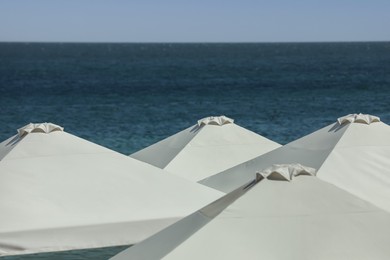 Photo of Many beach umbrellas at resort on sunny day