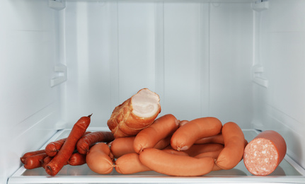 Photo of Sausages and meat products on shelf in refrigerator