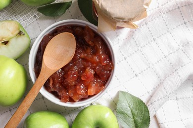 Photo of Bowl of delicious apple jam and fresh fruits on white tablecloth, flat lay. Space for text