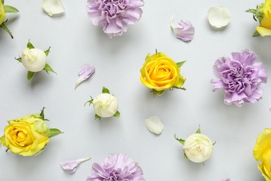 Photo of Flat lay composition with beautiful blooming flowers on grey background