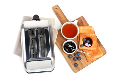 Toaster, bread with jam, blueberries and tea on white background, top view