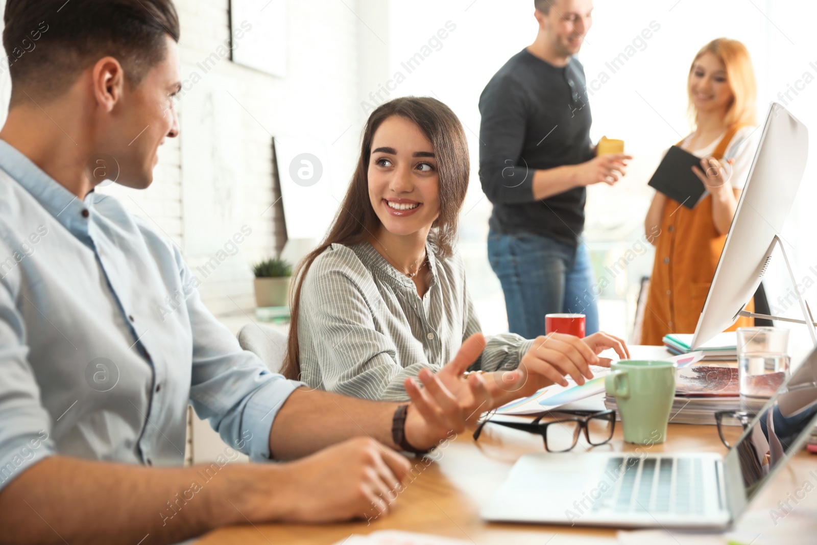 Photo of Team of professional designers working in office