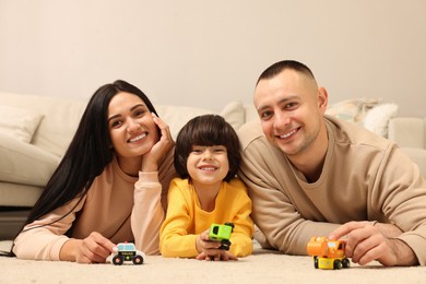 Happy family playing with toys together at home
