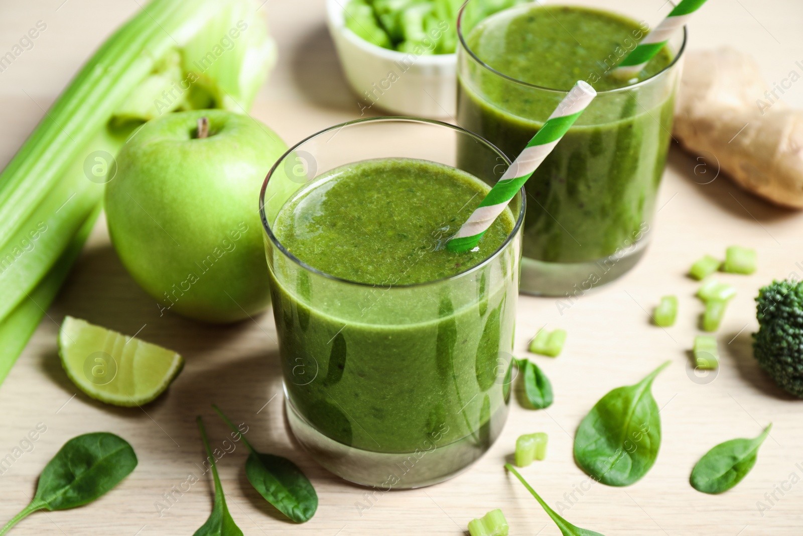 Photo of Delicious fresh green juice on wooden table