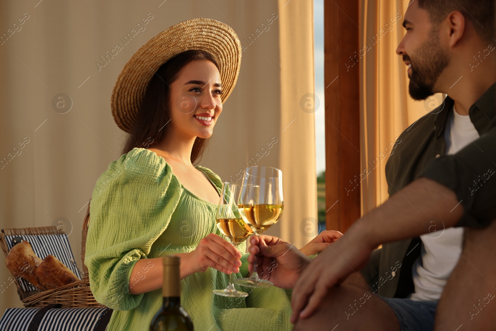 Photo of Romantic date. Beautiful couple with glasses of wine on sunny day