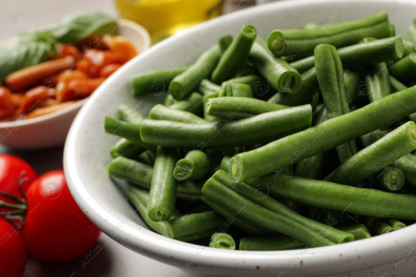 Photo of Fresh green beans and other ingredients for salad on table, closeup