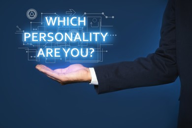 Image of Man showing question Which personality are you? on virtual screen against dark blue background, closeup 