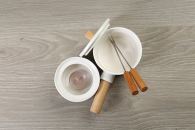 Photo of Fondue set on wooden table, flat lay