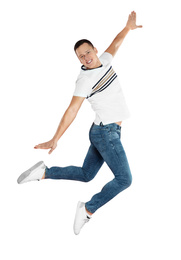 Handsome young man jumping on red background