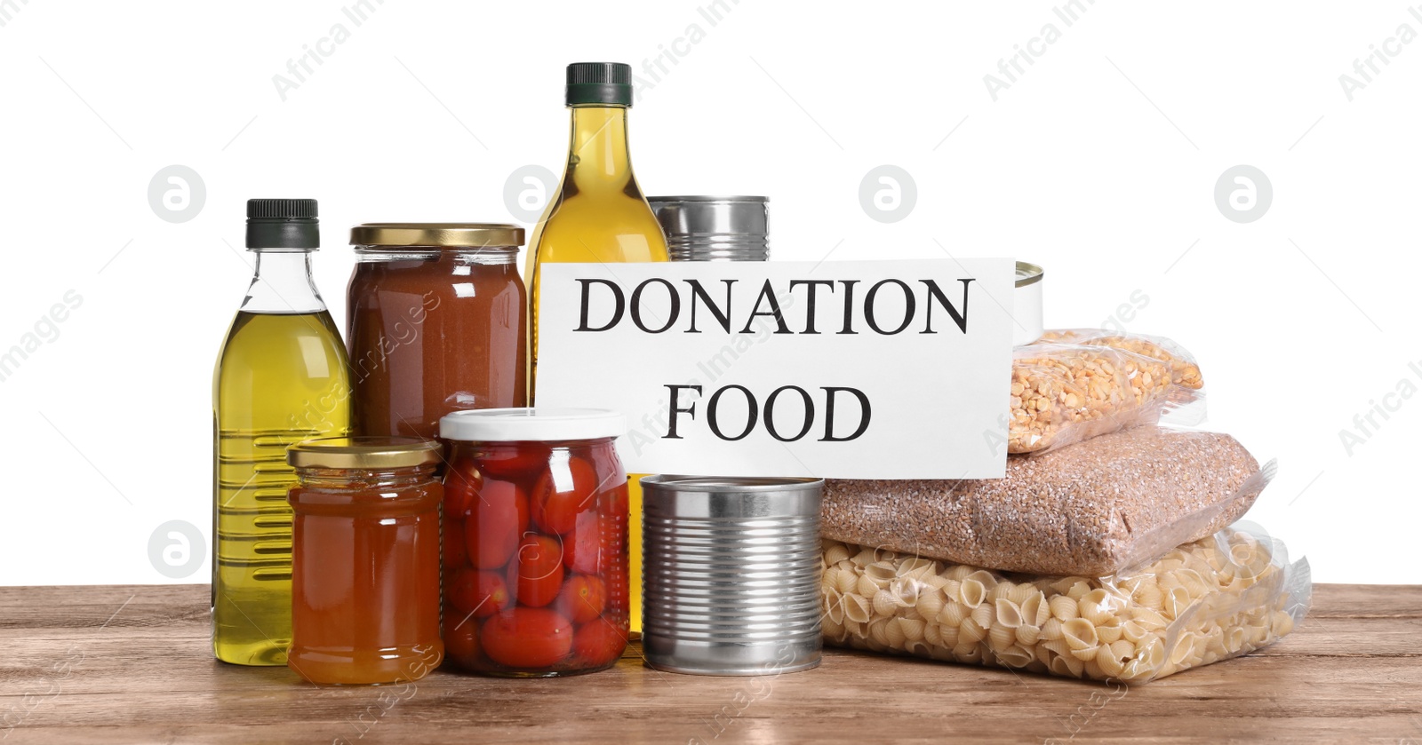 Photo of Card with words Donation Food and different products on wooden table against white background