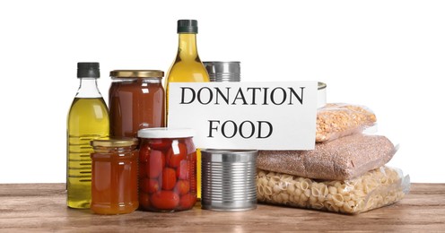 Card with words Donation Food and different products on wooden table against white background