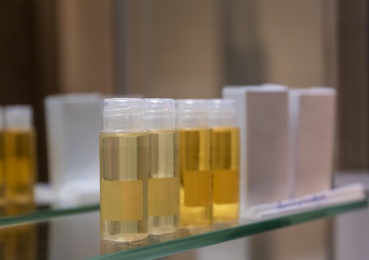 Photo of Hotel amenities on glass shelf near mirror in bathroom