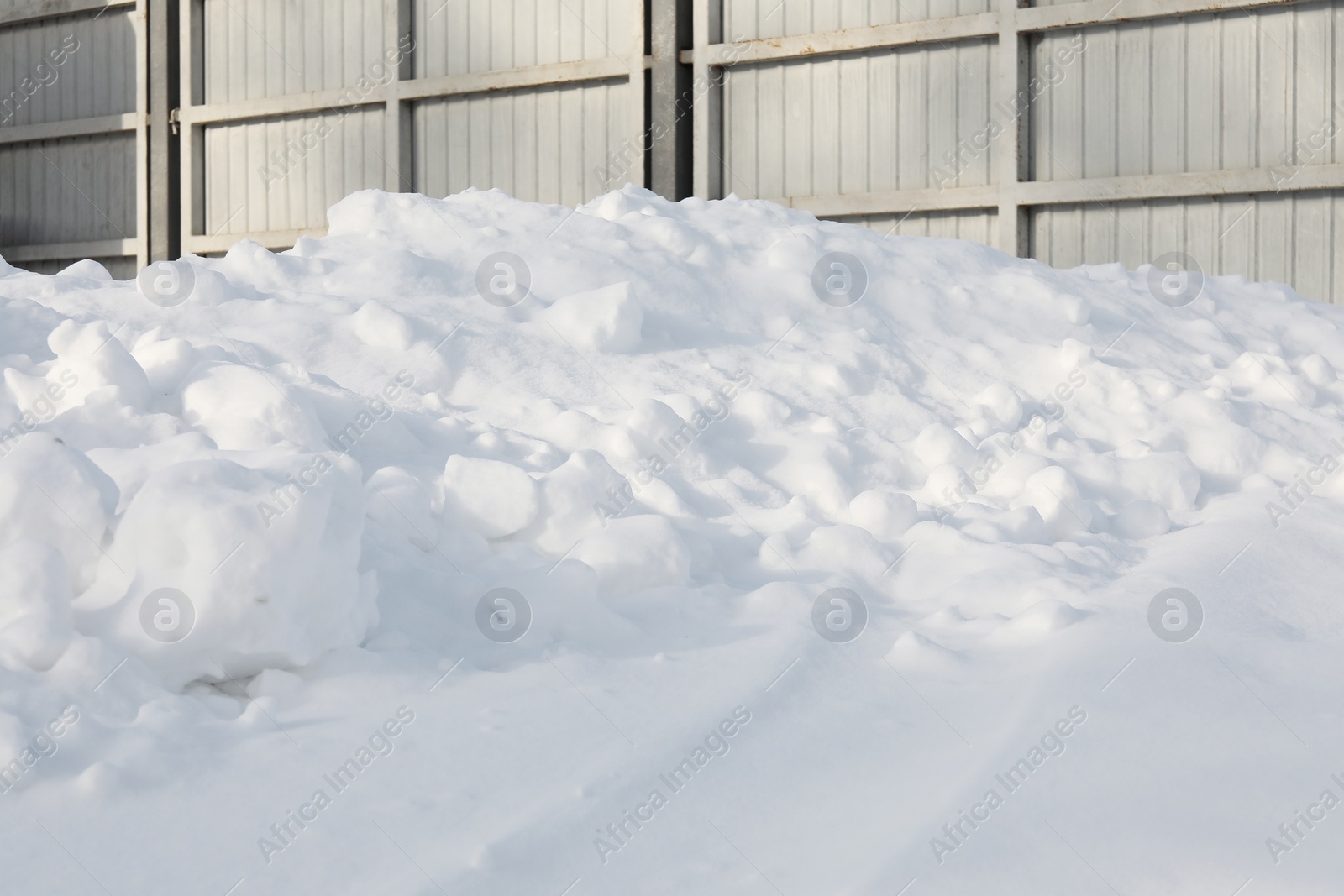 Photo of Beautiful snowdrift near gates outdoors. Winter season