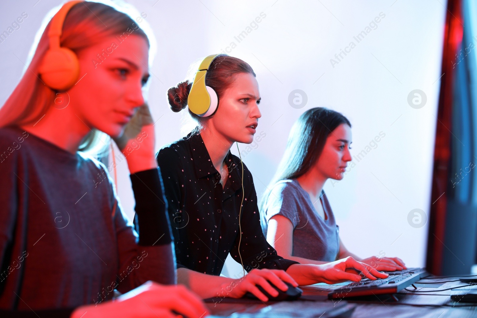 Photo of Young people playing video games on computers indoors. Esports tournament