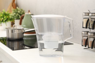 Photo of Water filter jug on white countertop in kitchen