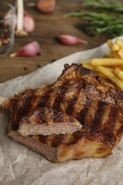 Tasty grilled beef steak on wooden table