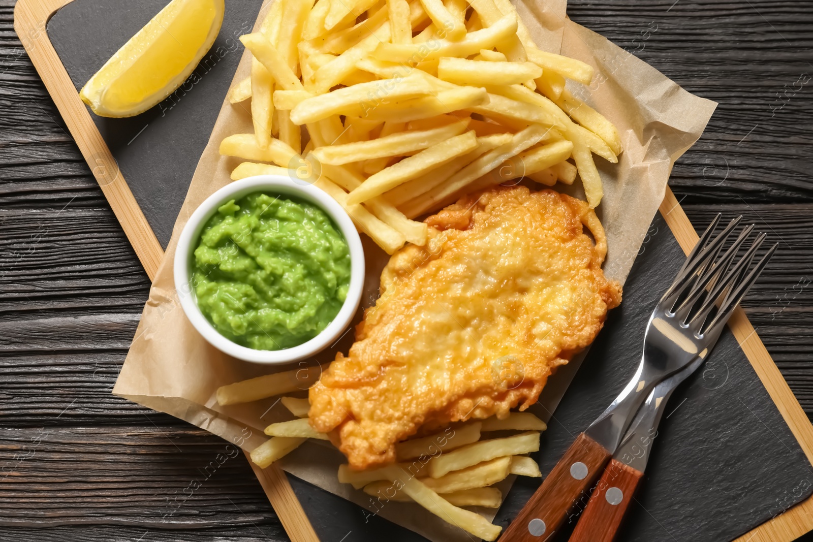 Photo of British Traditional Fish and potato chips on wooden background, top view