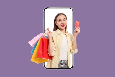 Image of Online shopping. Happy woman with paper bags and credit card looking out from smartphone on violet background