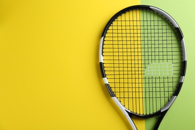 Tennis racket on color background, top view. Space for text
