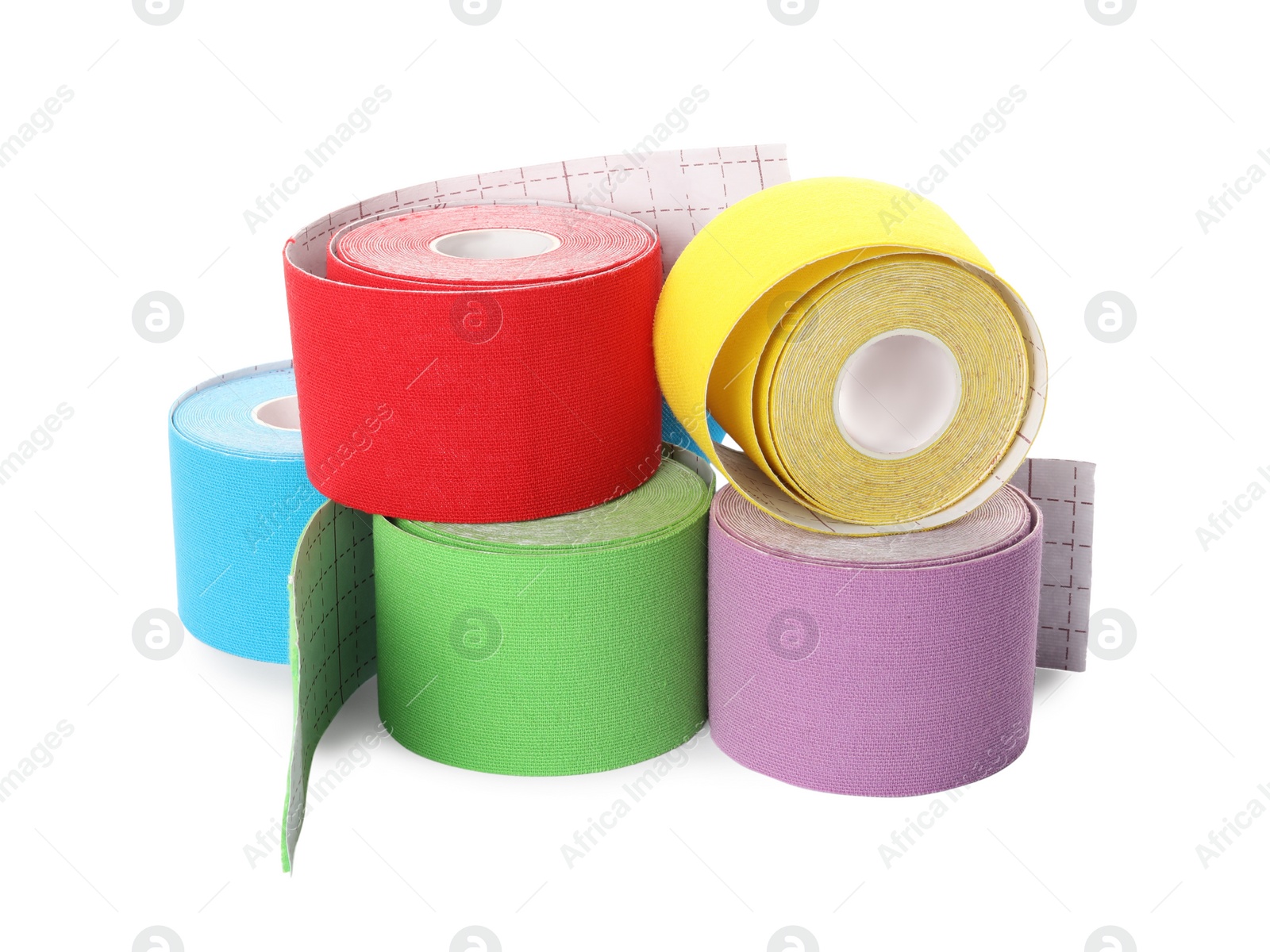 Photo of Many bright kinesio tape in rolls on white background