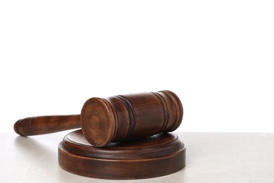 Photo of Wooden gavel on light table against white background. Space for text