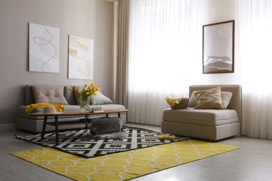 Photo of Stylish living room interior with comfortable sofa. Interior design in grey and yellow colors