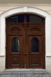 Photo of View of house with beautiful arched wooden door. Exterior design