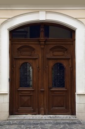 View of house with beautiful arched wooden door. Exterior design