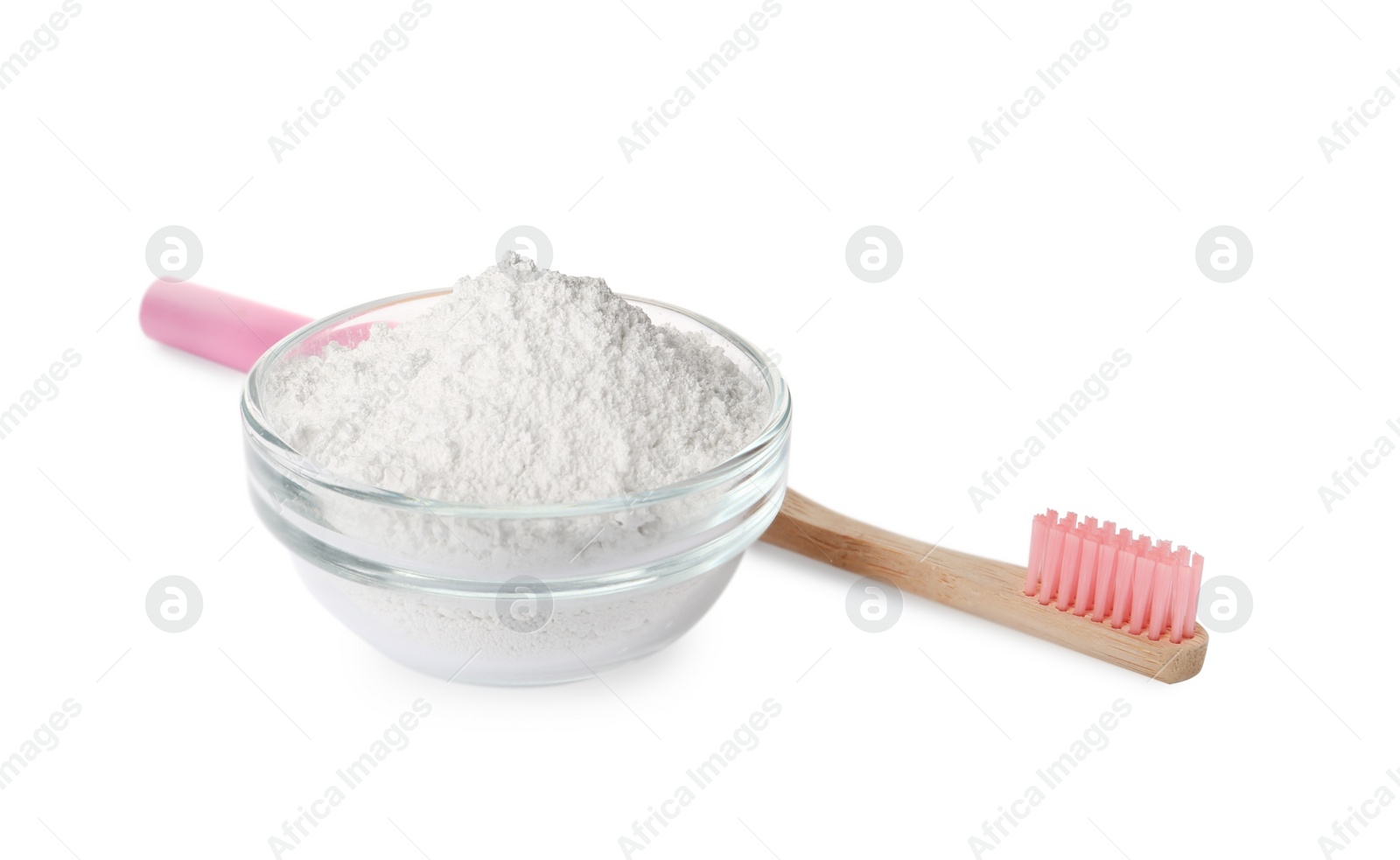 Photo of Glass bowl of tooth powder and brush on white background