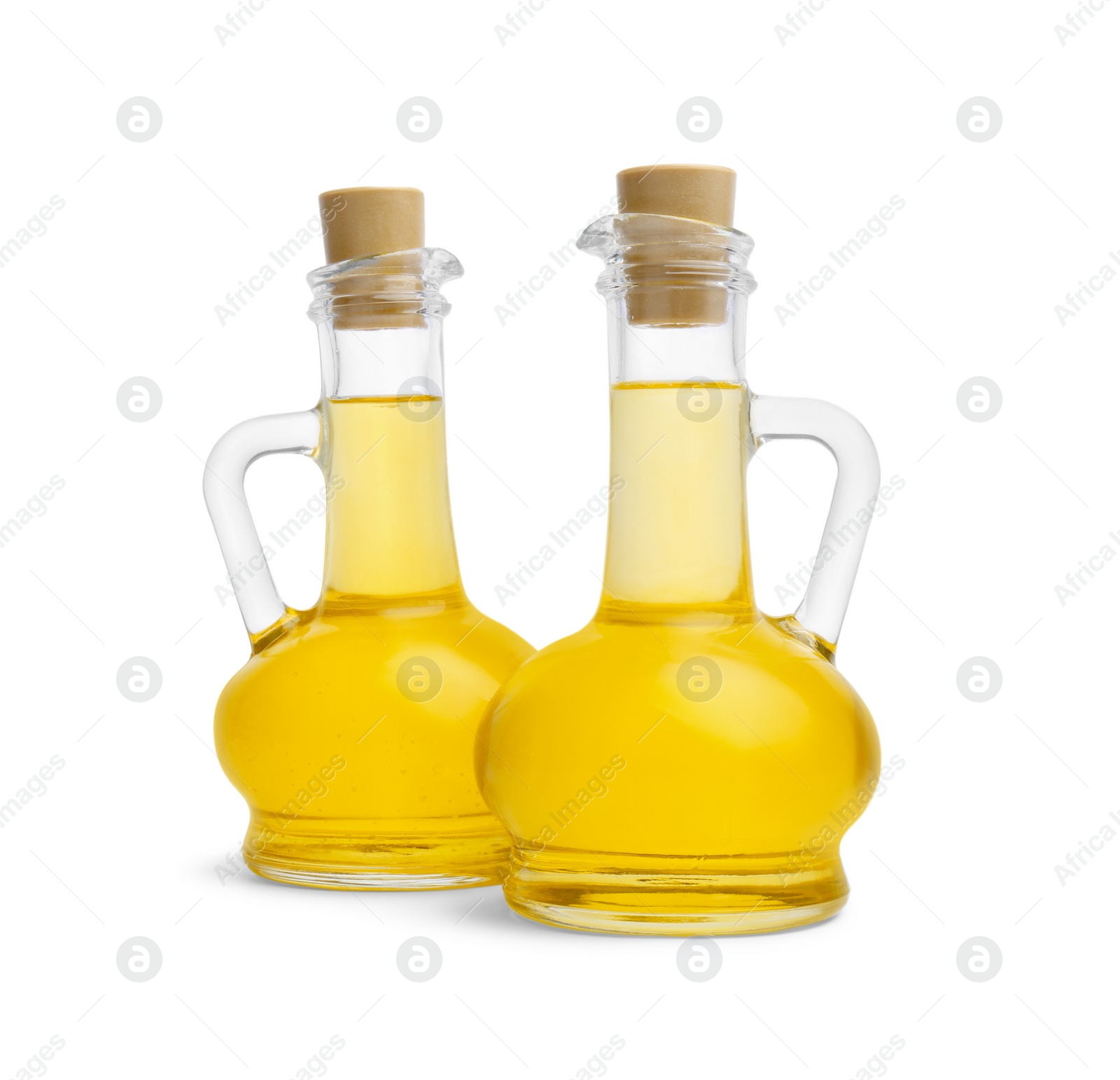 Photo of Glass jugs of cooking oil on white background