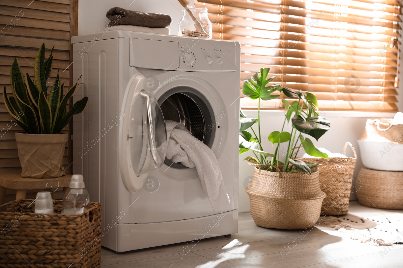 Photo of Stylish room interior with washing machine. Design idea