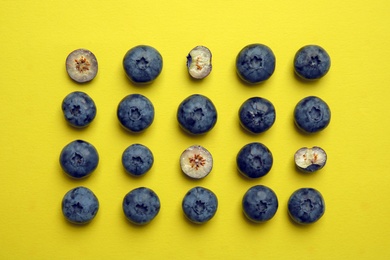 Flat lay composition with tasty blueberry on color background