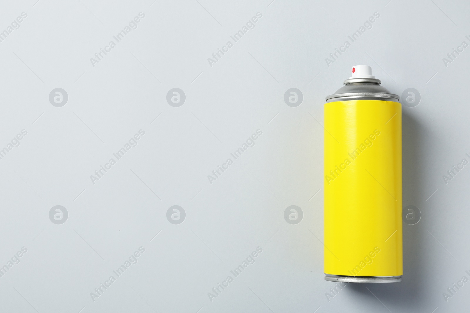 Photo of Can of spray paint on color background, top view. Space for text