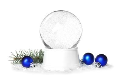 Photo of Magical empty snow globe with pine branch and Christmas balls on white background
