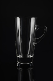 Photo of Clean empty latte glass on black background