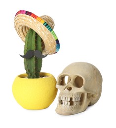 Cactus with Mexican sombrero hat, fake mustache and human scull isolated on white