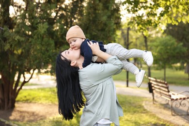 Happy mother having fun with her baby in park