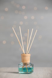Photo of Aromatic reed air freshener on wooden table