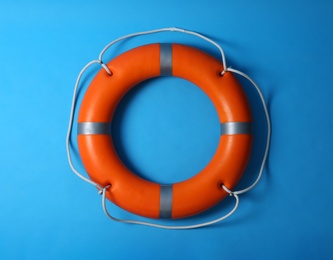 Orange lifebuoy on blue background. Rescue equipment