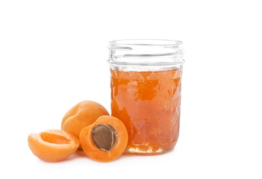 Photo of Jar with delicious apricot jam and fruit on white background