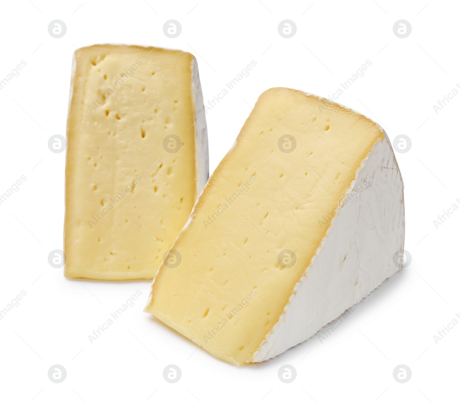 Photo of Pieces of tasty camembert cheese isolated on white