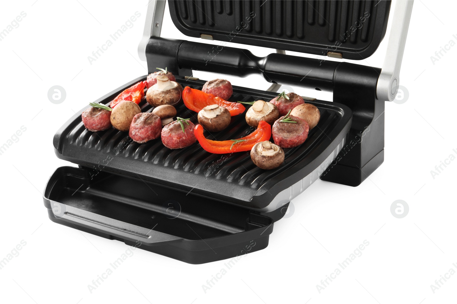 Photo of Electric grill with meat balls, bell pepper and mushrooms isolated on white