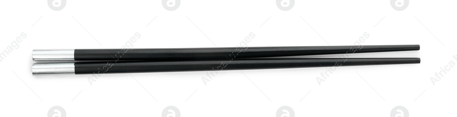 Photo of Pair of black chopsticks isolated on white, top view